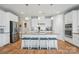 Bright kitchen with white cabinets, stainless steel appliances, and a spacious island with bar stools at 333 Dudley Dr, Fort Mill, SC 29715