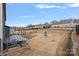 Spacious backyard with a retaining wall, a little blue house and brown grass at 3439 Duchess Ave, Fort Mill, SC 29707