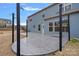 A backyard stamped concrete patio with black steel posts and the house in the background at 3439 Duchess Ave, Fort Mill, SC 29707