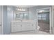 Bathroom with a large mirror, white cabinets, granite countertop, and a view to the bedroom at 3439 Duchess Ave, Fort Mill, SC 29707