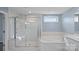 Bathroom with a glass shower, a window, and a soaking tub at 3439 Duchess Ave, Fort Mill, SC 29707