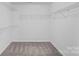 A simple walk-in closet with a carpeted floor and shelving racks at 3439 Duchess Ave, Fort Mill, SC 29707