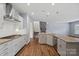 Open kitchen with a center island, stone fireplace, and stainless steel appliances at 3439 Duchess Ave, Fort Mill, SC 29707