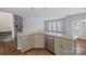 Kitchen island with granite countertops and view to a living room with a fireplace at 3439 Duchess Ave, Fort Mill, SC 29707