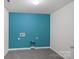 Well-lit laundry room featuring a vibrant blue accent wall and tile floor at 3439 Duchess Ave, Fort Mill, SC 29707