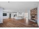 Open concept living area with a stone fireplace, hardwood floors, and a kitchen island at 3439 Duchess Ave, Fort Mill, SC 29707