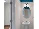 Powder room featuring a pedestal sink, oval mirror, and modern lighting at 3439 Duchess Ave, Fort Mill, SC 29707