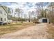 A gravel backyard with a large shed, and fenced animal enclosures at 360 Patience Dr, Concord, NC 28025