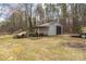 A view of the barn with large garage door, surrounded by tools, tractors and equipment at 360 Patience Dr, Concord, NC 28025