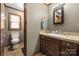 A cozy bathroom featuring a granite countertop sink, a window, and a toilet at 360 Patience Dr, Concord, NC 28025