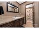 A bathroom featuring granite countertops, a tile backsplash, and a cabinet sink with decorative accents at 360 Patience Dr, Concord, NC 28025