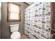 A full bathroom showcases a toilet and a patterned shower curtain at 360 Patience Dr, Concord, NC 28025