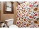 Full bath featuring a toilet, a window, and a shower curtain with floral design at 360 Patience Dr, Concord, NC 28025