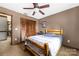This lovely bedroom features a ceiling fan, wood-trimmed closet doors, and carpeted floors at 360 Patience Dr, Concord, NC 28025