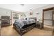 A comfy bedroom features carpeted floors, natural light, and a wooden bed frame at 360 Patience Dr, Concord, NC 28025