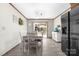 Sunlit dining area showcasing wood-look floors, modern furniture, and a stylish coffee bar at 360 Patience Dr, Concord, NC 28025