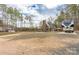 Expansive back yard with gravel parking, showing the house and outdoor living area at 360 Patience Dr, Concord, NC 28025