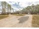 Spacious property showcasing a long driveway and large lot with mature trees surrounding the home at 360 Patience Dr, Concord, NC 28025