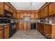 Traditional kitchen with wood cabinetry, granite countertops, and stylish backsplash detailing at 360 Patience Dr, Concord, NC 28025