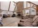 Spacious living room featuring a large brick fireplace, vaulted ceilings with wooden beams, and ample natural light at 360 Patience Dr, Concord, NC 28025