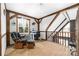 Inviting loft area featuring exposed beams, a cozy chair, and a functional workspace at 360 Patience Dr, Concord, NC 28025