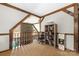 Loft area with exposed beams and a view to the living area below, featuring shelving and decor at 360 Patience Dr, Concord, NC 28025