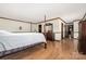 A large main bedroom featuring wood floors and neutral walls with a view to the hallway and other rooms at 360 Patience Dr, Concord, NC 28025