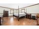 A bedroom with wood floors, complemented by natural light and a four-poster bed at 360 Patience Dr, Concord, NC 28025