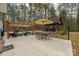 A covered patio featuring an outdoor living space with comfortable seating, dining table, and umbrella at 360 Patience Dr, Concord, NC 28025