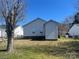 Exterior view of the home, highlighting a well-maintained backyard with lawn and a storage shed at 376 Brookgreen Nw Pl, Concord, NC 28027
