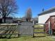 View of a backyard featuring a weathered wooden fence with a latching gate and green grass at 376 Brookgreen Nw Pl, Concord, NC 28027