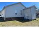Backyard view showing the home's exterior, well-maintained lawn, and a storage shed for added convenience at 376 Brookgreen Nw Pl, Concord, NC 28027