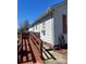 Exterior view of the home featuring a wooden ramp leading to the entrance, offering accessibility and convenience at 376 Brookgreen Nw Pl, Concord, NC 28027