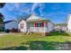 Cozy single-story home with white siding, red shutters, and a small front porch at 376 Brookgreen Nw Pl, Concord, NC 28027