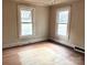 Sunny bedroom featuring natural light and an original hardwood floor at 4137 Poplar Tent Rd, Concord, NC 28027