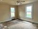 Bright bedroom with natural light and hardwood floors ready to be restored at 4137 Poplar Tent Rd, Concord, NC 28027