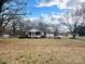 Charming one-story brick home with a screened-in porch and spacious front lawn at 4137 Poplar Tent Rd, Concord, NC 28027