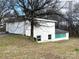 Spacious detached two car garage with additional storage space and a tree nearby at 4137 Poplar Tent Rd, Concord, NC 28027