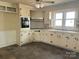 Functional kitchen with classic cabinetry, laminate countertops and a view of the yard at 4137 Poplar Tent Rd, Concord, NC 28027