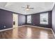 Spacious bedroom with tray ceilings, hardwood floors, and ample natural light from two large windows at 439 Newfound Hollow Dr, Charlotte, NC 28214