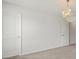 Spacious bedroom featuring a crystal chandelier, white walls, and plush carpeting, blending modern design with classic comfort at 439 Newfound Hollow Dr, Charlotte, NC 28214