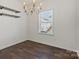 Dining area featuring a modern chandelier, window, and hardwood floors at 439 Newfound Hollow Dr, Charlotte, NC 28214