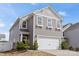 Charming two-story home featuring a gray exterior, a two-car garage, and well-maintained landscaping at 439 Newfound Hollow Dr, Charlotte, NC 28214