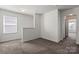 Bright hallway featuring neutral walls and plush carpeting, creating a welcoming transition between spaces at 439 Newfound Hollow Dr, Charlotte, NC 28214