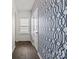 Hallway with window and white door featuring a stylish patterned blue wallpaper for a modern touch at 439 Newfound Hollow Dr, Charlotte, NC 28214
