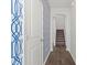 Hallway with dark wood floors, stairway, and patterned blue wallpaper adds a stylish touch to the home at 439 Newfound Hollow Dr, Charlotte, NC 28214