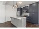 Stylish kitchen island featuring pendant lights, sink, and stainless appliances at 439 Newfound Hollow Dr, Charlotte, NC 28214