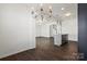 Spacious living room with hardwood floors, modern lighting and open kitchen at 439 Newfound Hollow Dr, Charlotte, NC 28214