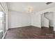 Spacious living room with hardwood floors, white walls, modern lighting, and sliding glass door at 439 Newfound Hollow Dr, Charlotte, NC 28214
