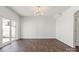 Spacious living room with hardwood floors, white walls, modern lighting, and sliding glass door at 439 Newfound Hollow Dr, Charlotte, NC 28214
